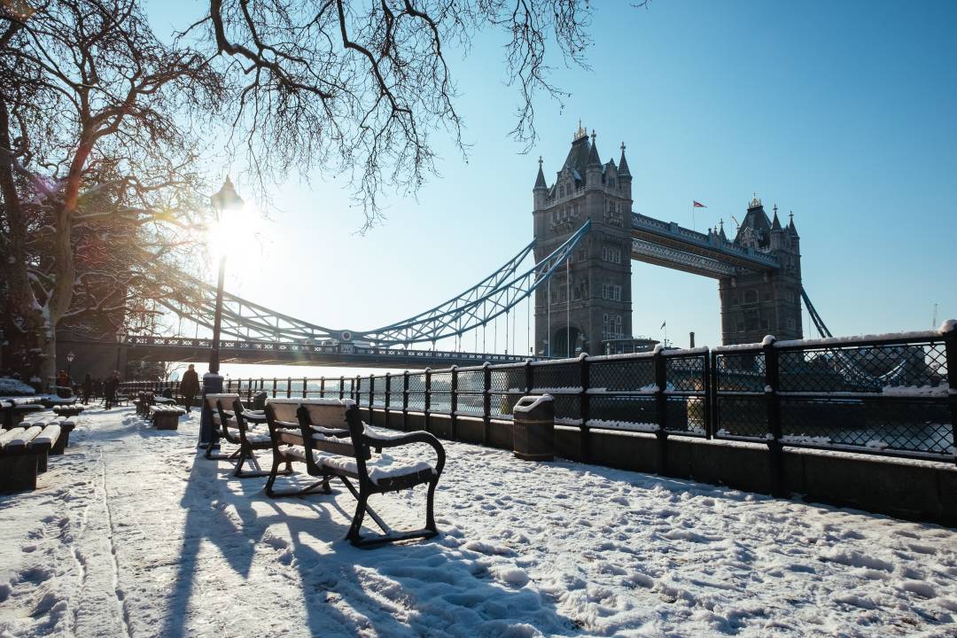 View of Tower Bridge from the South Bank on a sunny winter day with a dusting of snow